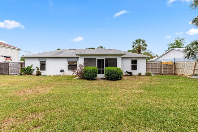 3214 Juniper Dr, Edgewater, FL 32141 - rear view of house with stucco siding, a yard, and a fenced backyard