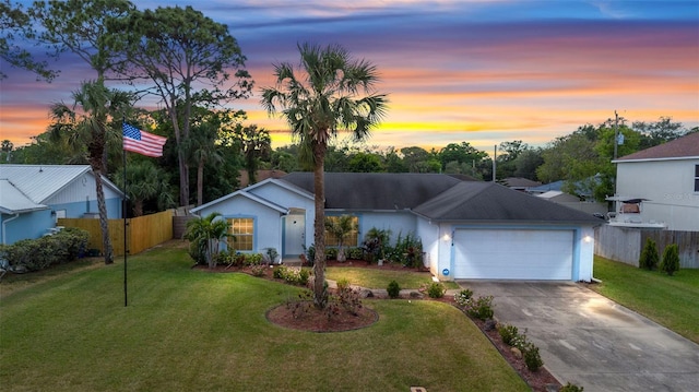3214 Juniper Dr, Edgewater, FL 32141 - ranch-style home with an attached garage, fence, a yard, and concrete driveway