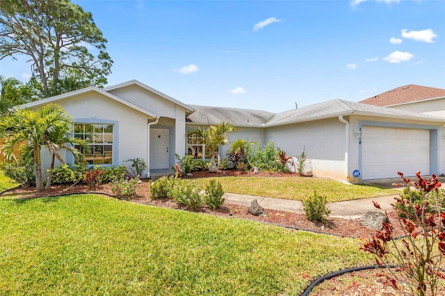 3214 Juniper Dr, Edgewater, FL 32141 - ranch-style home featuring an attached garage, a front yard, and stucco siding