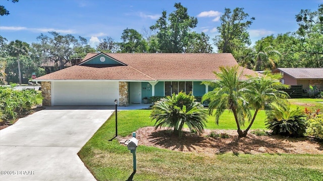 ranch-style house with an attached garage, driveway, stone siding, and a front yard