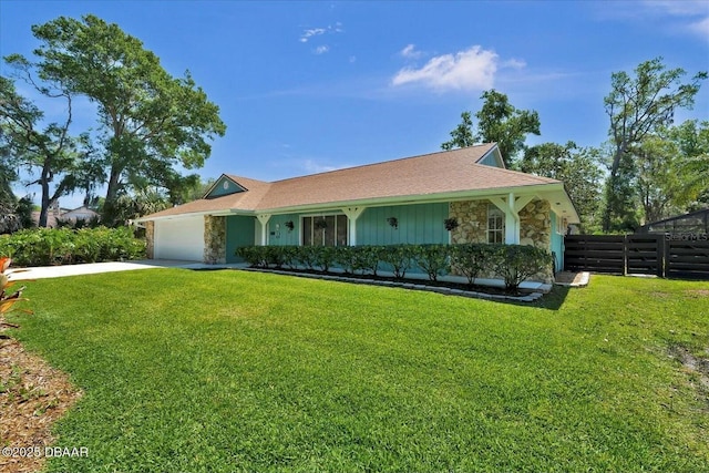 view of front of house with fence, stone siding, driveway, and a garage