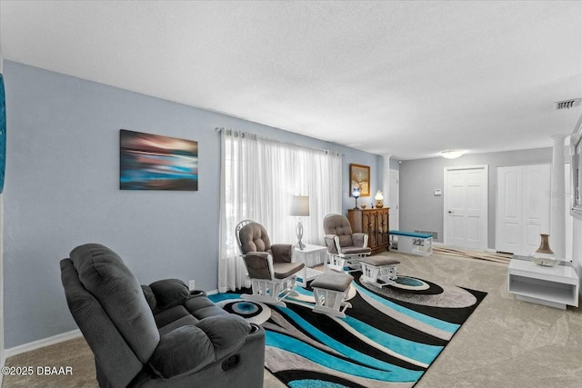 living room featuring baseboards, a textured ceiling, visible vents, and carpet