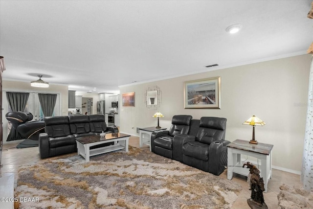 living room featuring baseboards, visible vents, light tile patterned floors, and crown molding