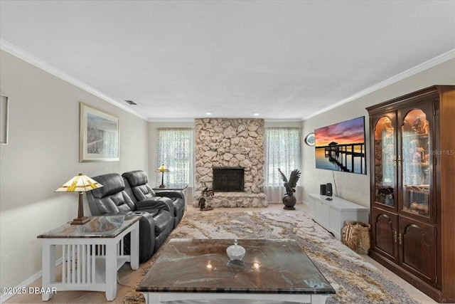 living room featuring baseboards, crown molding, visible vents, and a fireplace