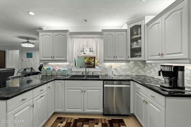 kitchen with backsplash, stainless steel dishwasher, a sink, a peninsula, and a textured ceiling