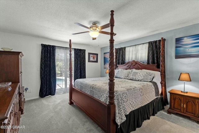 bedroom with a ceiling fan, carpet floors, access to exterior, and multiple windows