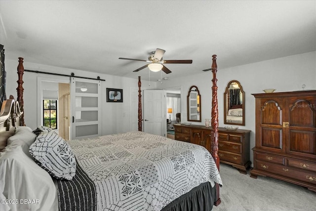 bedroom featuring light colored carpet, a barn door, and ceiling fan
