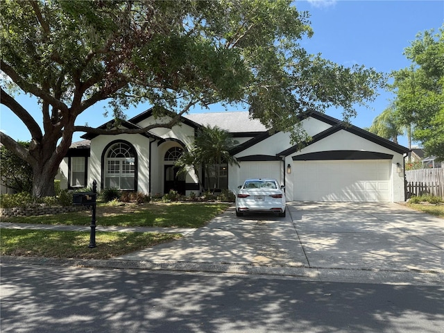 4749 Stoneview Cir, Oldsmar, FL 34677 - view of front facade featuring a garage, concrete driveway, and stucco siding