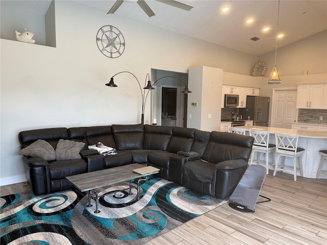 4749 Stoneview Cir, Oldsmar, FL 34677 - living area featuring light wood finished floors, high vaulted ceiling, and ceiling fan