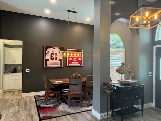 4749 Stoneview Cir, Oldsmar, FL 34677 - dining area featuring light wood-style floors, a chandelier, baseboards, and recessed lighting