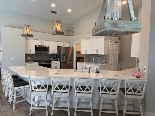 4749 Stoneview Cir, Oldsmar, FL 34677 - kitchen with stainless steel appliances, a sink, island range hood, a peninsula, and decorative backsplash