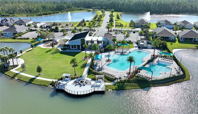 birds eye view of property featuring a forest view and a water view