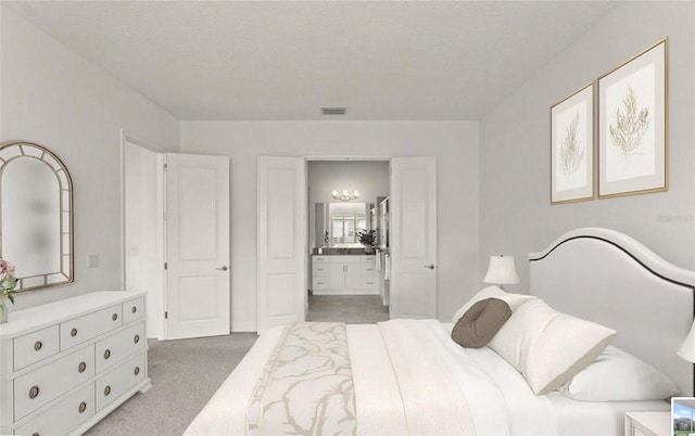carpeted bedroom with connected bathroom and visible vents