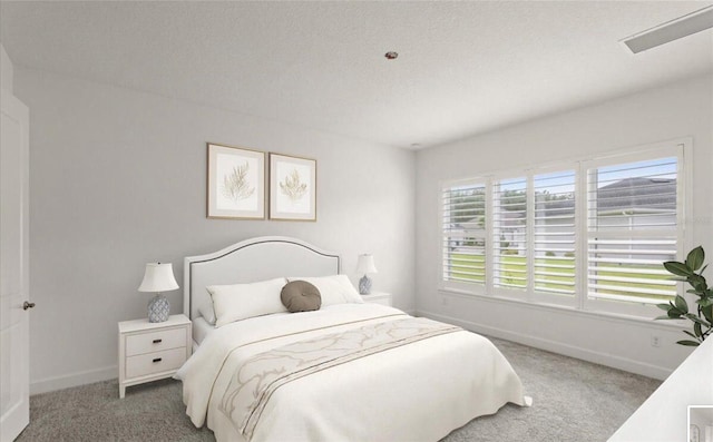 carpeted bedroom featuring baseboards