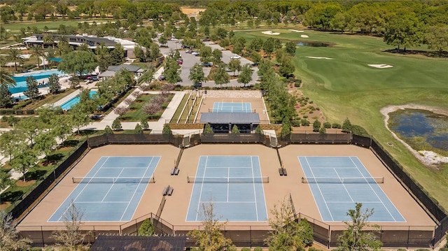 drone / aerial view featuring a water view and view of golf course