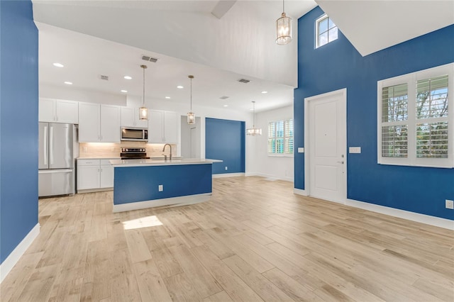 484 Landshark Blvd, Daytona Beach, FL 32124 - kitchen with visible vents, white cabinets, a wealth of natural light, and stainless steel appliances