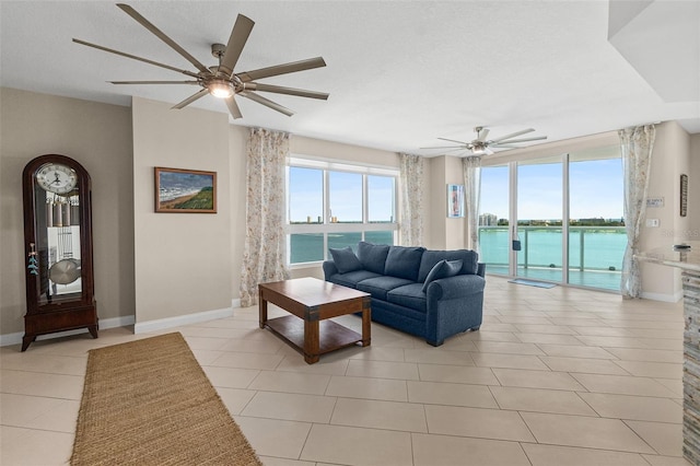 241 Riverside Dr Unit 902, Holly Hill, FL 32117 - living room with baseboards, a ceiling fan, and light tile patterned floors