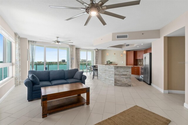 241 Riverside Dr Unit 902, Holly Hill, FL 32117 - living area featuring baseboards, a ceiling fan, visible vents, and light tile patterned floors