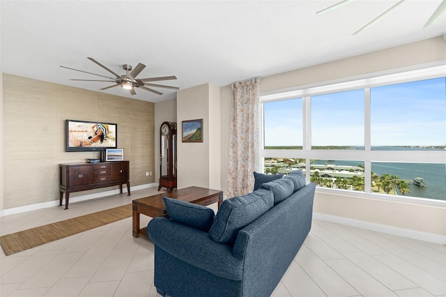 241 Riverside Dr Unit 902, Holly Hill, FL 32117 - living room featuring a ceiling fan, baseboards, an accent wall, and a water view