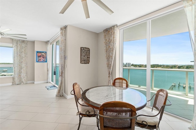 241 Riverside Dr Unit 902, Holly Hill, FL 32117 - dining space featuring ceiling fan, a wealth of natural light, and a water view