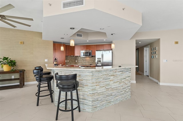 241 Riverside Dr Unit 902, Holly Hill, FL 32117 - kitchen featuring a peninsula, visible vents, decorative backsplash, a ceiling fan, and appliances with stainless steel finishes