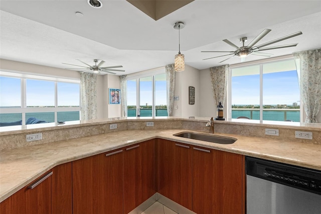 241 Riverside Dr Unit 902, Holly Hill, FL 32117 - kitchen with a sink, brown cabinetry, a water view, dishwasher, and ceiling fan