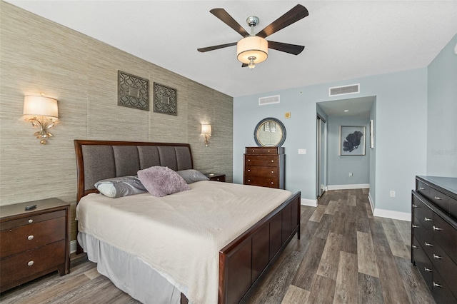 241 Riverside Dr Unit 902, Holly Hill, FL 32117 - bedroom featuring baseboards, visible vents, an accent wall, and dark wood finished floors