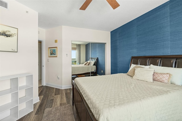 241 Riverside Dr Unit 902, Holly Hill, FL 32117 - bedroom with visible vents, an accent wall, a closet, baseboards, and dark wood-style flooring