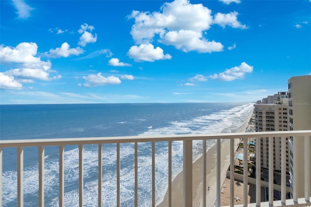 balcony featuring a beach view and a water view