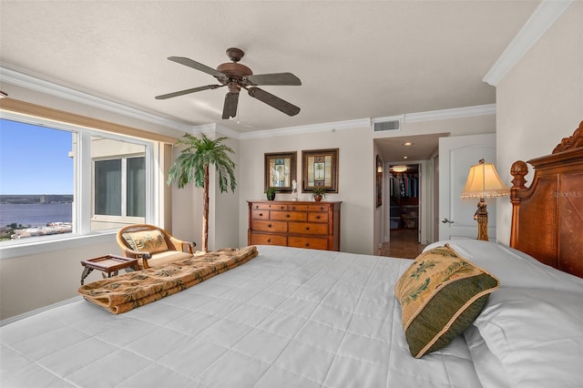 bedroom featuring ornamental molding, a ceiling fan, visible vents, and baseboards