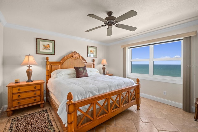 bedroom with baseboards, ornamental molding, a ceiling fan, and stone tile flooring