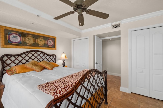 bedroom with stone tile flooring, a closet, ornamental molding, baseboards, and visible vents