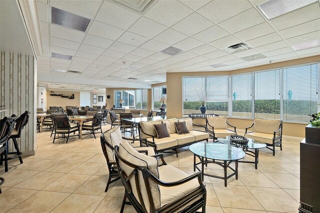 interior space featuring light tile patterned floors, visible vents, and a paneled ceiling