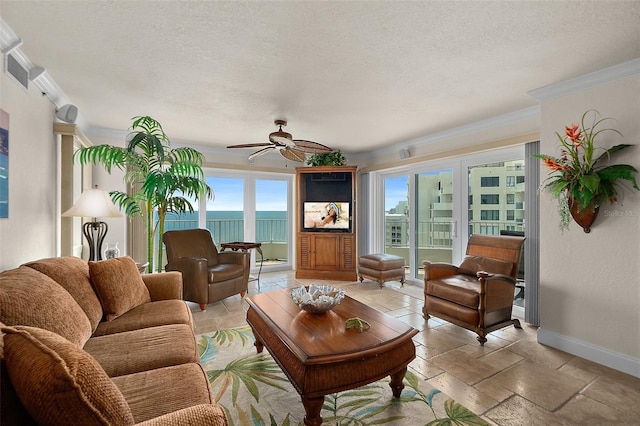 living area featuring a ceiling fan, visible vents, a textured ceiling, and baseboards