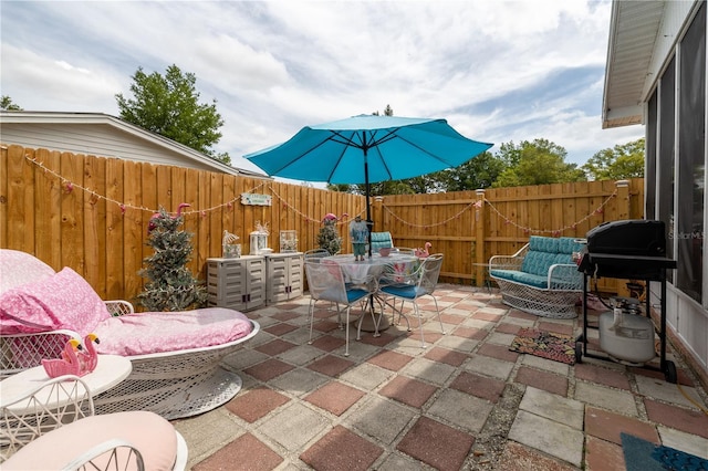 1148 Briarwood Ave, Deltona, FL 32725 - view of patio with a fenced backyard, outdoor dining area, and a grill