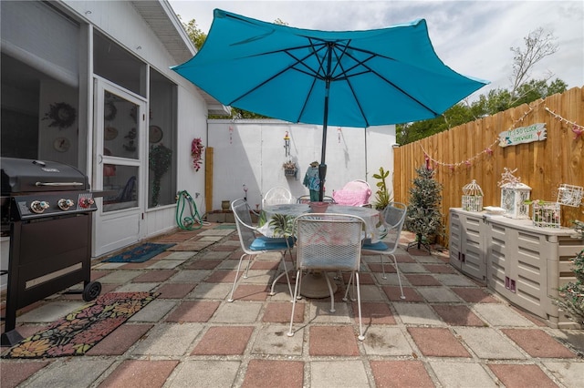 1148 Briarwood Ave, Deltona, FL 32725 - view of patio with a sunroom, a fenced backyard, and outdoor dining area