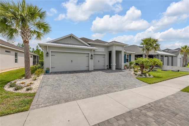 660 Mosaic Blvd, Daytona Beach, FL 32124 - view of front of house with a garage, decorative driveway, stucco siding, and a front yard
