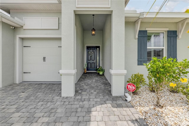 660 Mosaic Blvd, Daytona Beach, FL 32124 - entrance to property featuring stucco siding, a garage, and a surveillance system