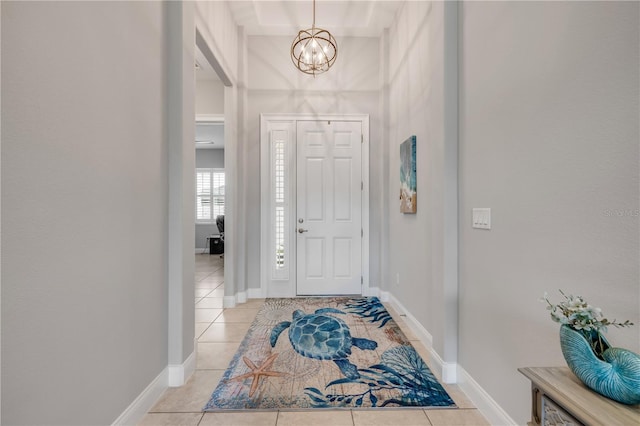 660 Mosaic Blvd, Daytona Beach, FL 32124 - entryway featuring a chandelier, light tile patterned floors, and baseboards