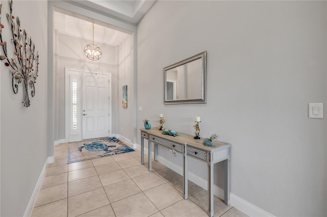 660 Mosaic Blvd, Daytona Beach, FL 32124 - foyer entrance featuring a chandelier, light tile patterned floors, and baseboards