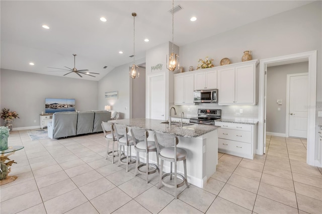 660 Mosaic Blvd, Daytona Beach, FL 32124 - kitchen featuring stainless steel appliances, a sink, light tile patterned floors, decorative backsplash, and light stone countertops