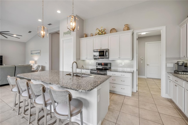 660 Mosaic Blvd, Daytona Beach, FL 32124 - kitchen featuring appliances with stainless steel finishes, a sink, decorative backsplash, open floor plan, and light tile patterned floors