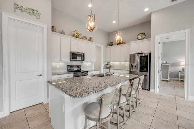 660 Mosaic Blvd, Daytona Beach, FL 32124 - kitchen with a sink, appliances with stainless steel finishes, light tile patterned flooring, white cabinets, and recessed lighting