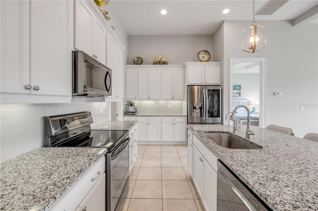 660 Mosaic Blvd, Daytona Beach, FL 32124 - kitchen featuring appliances with stainless steel finishes, a sink, white cabinets, decorative backsplash, and recessed lighting
