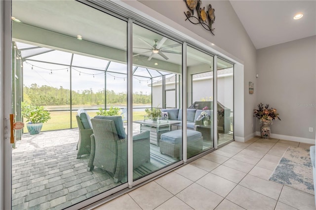 660 Mosaic Blvd, Daytona Beach, FL 32124 - doorway with a ceiling fan, healthy amount of natural light, light tile patterned flooring, baseboards, and vaulted ceiling