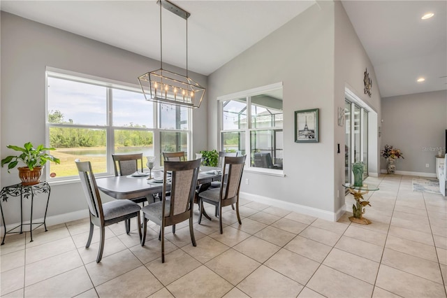 660 Mosaic Blvd, Daytona Beach, FL 32124 - dining space with baseboards, light tile patterned flooring, a chandelier, recessed lighting, and lofted ceiling
