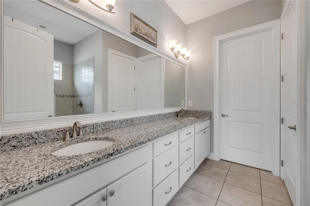 660 Mosaic Blvd, Daytona Beach, FL 32124 - bathroom featuring double vanity, tile patterned floors, and tiled shower