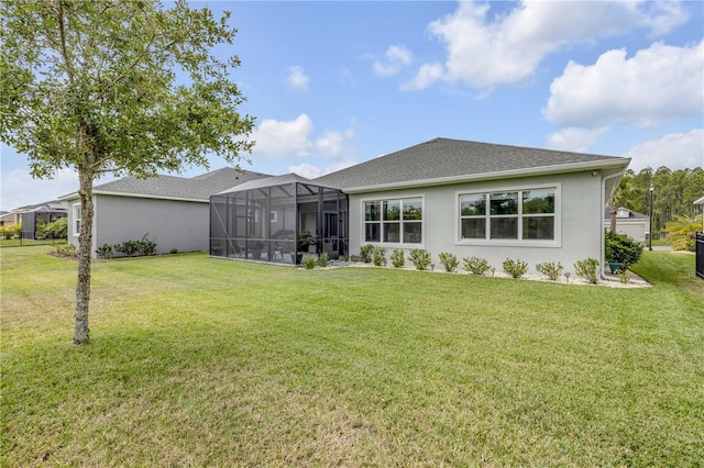 660 Mosaic Blvd, Daytona Beach, FL 32124 - back of house with a yard, stucco siding, a lanai, and roof with shingles