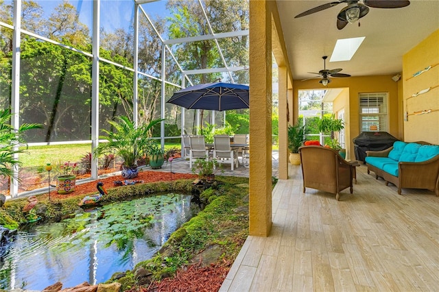 sunroom with a garden pond and a skylight