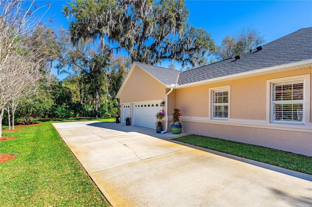 view of home's exterior featuring a lawn, driveway, a shingled roof, an attached garage, and stucco siding